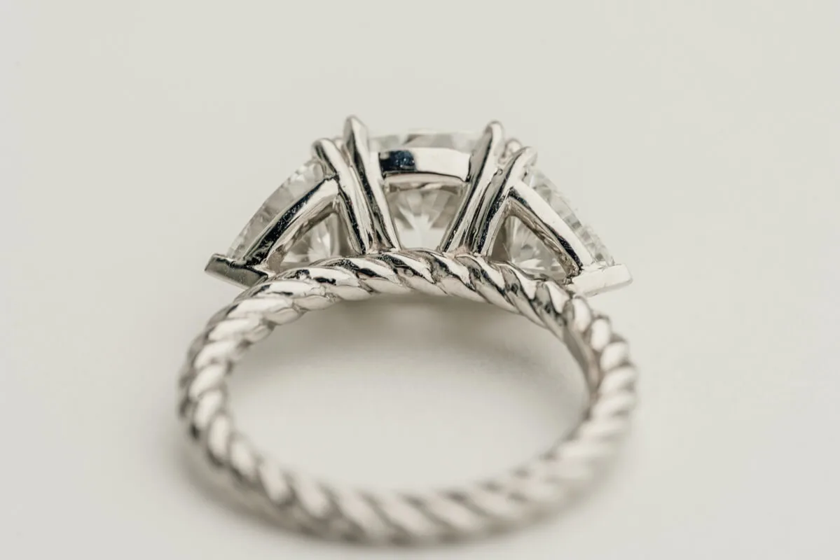 Twisted shank ring with trillion-cut side diamonds