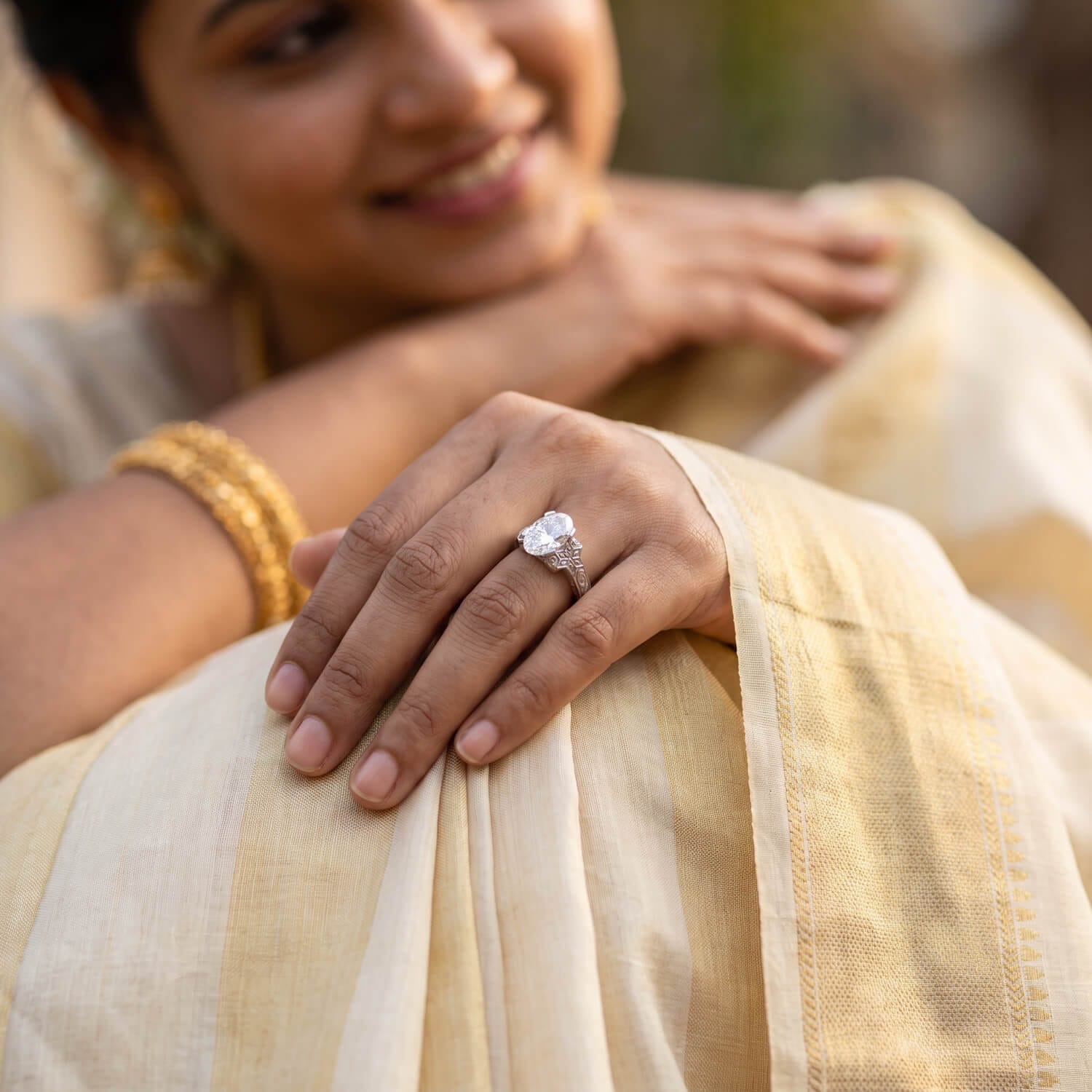 Custom Coimbatore-inspired oval diamond heritage ring on hand