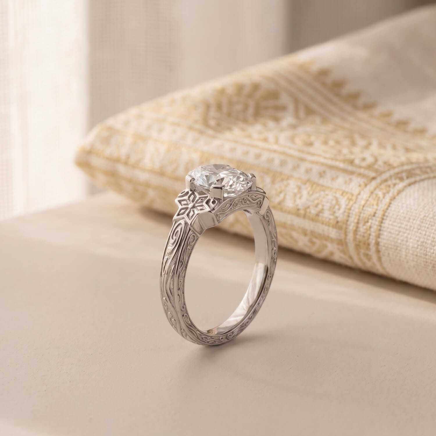 Side view of an oval diamond bezel heritage engagement ring