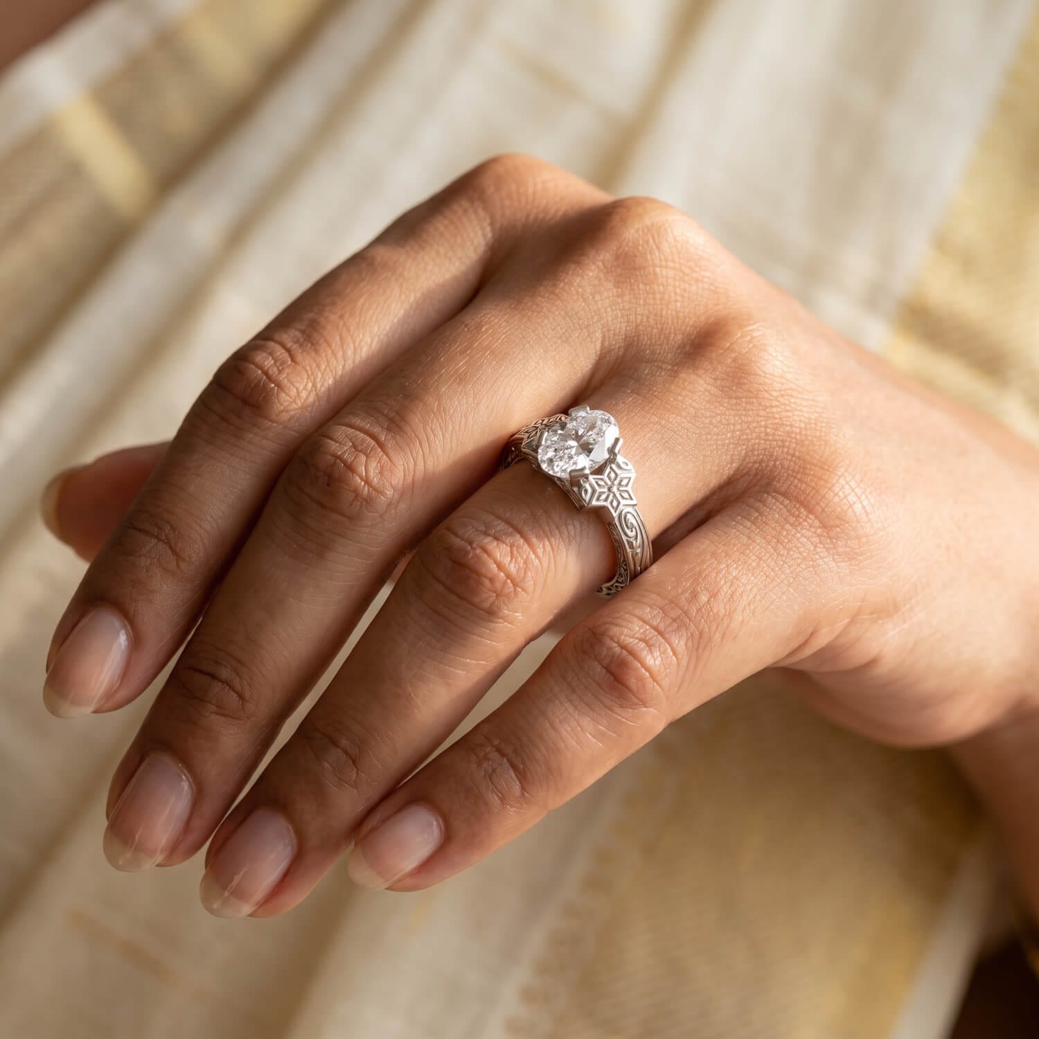 Oval diamond bezel heritage ring with sculpted white-gold shank