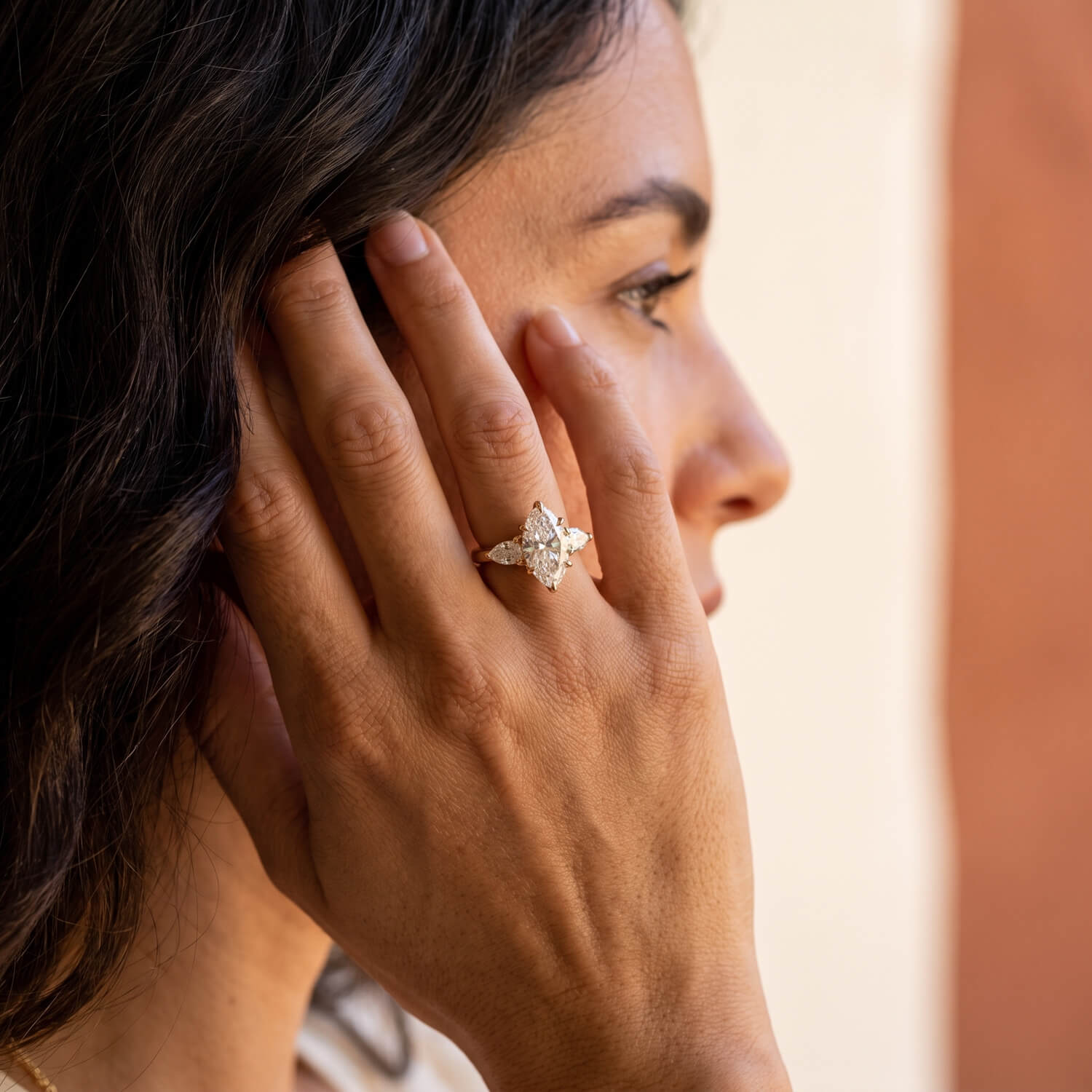 Lab-grown diamond elongated oval engagement ring on hand