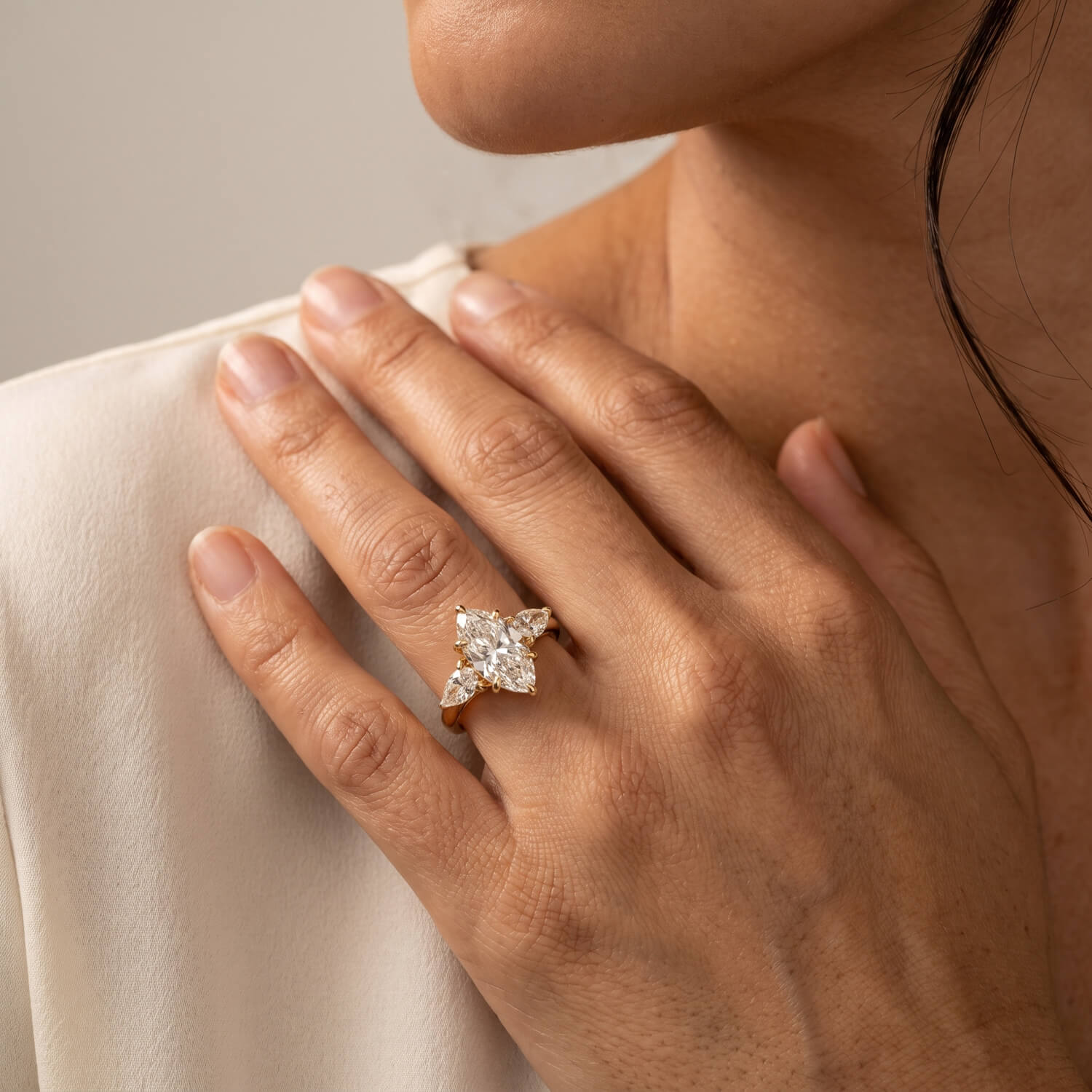 Elongated oval trilogy engagement ring at wearing scale