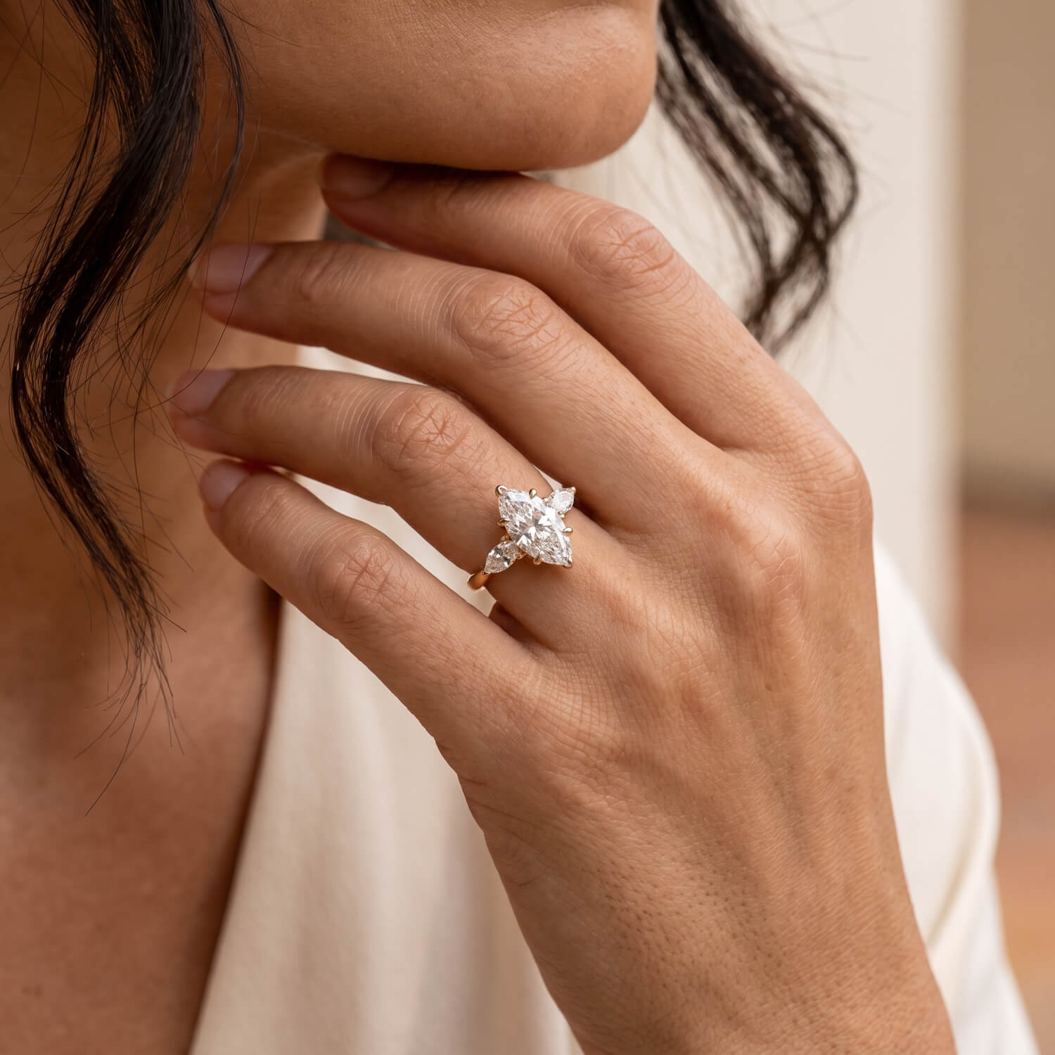 Three-stone lab-grown diamond engagement ring on model hand