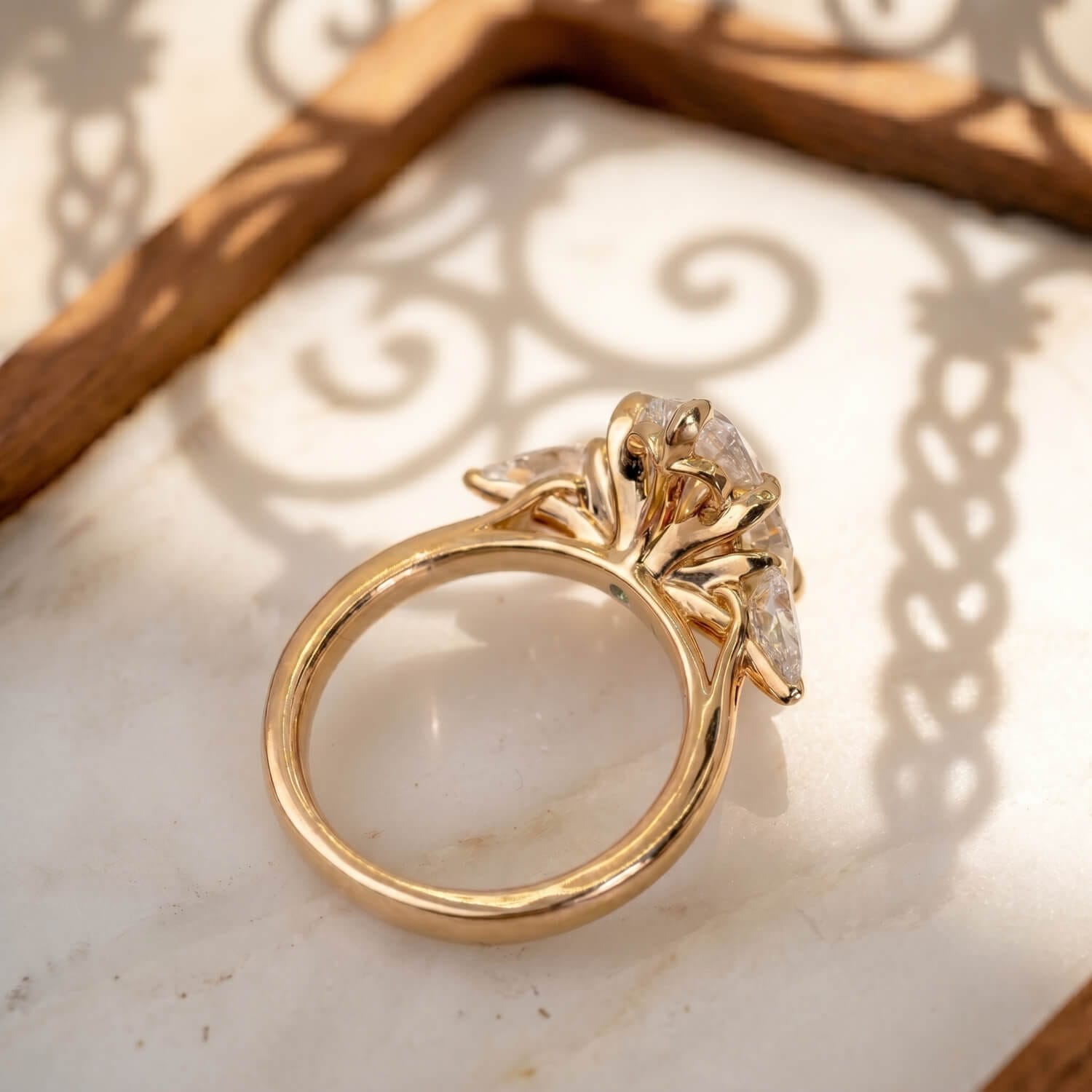 Spanish-inspired floral goldwork beneath the center diamond