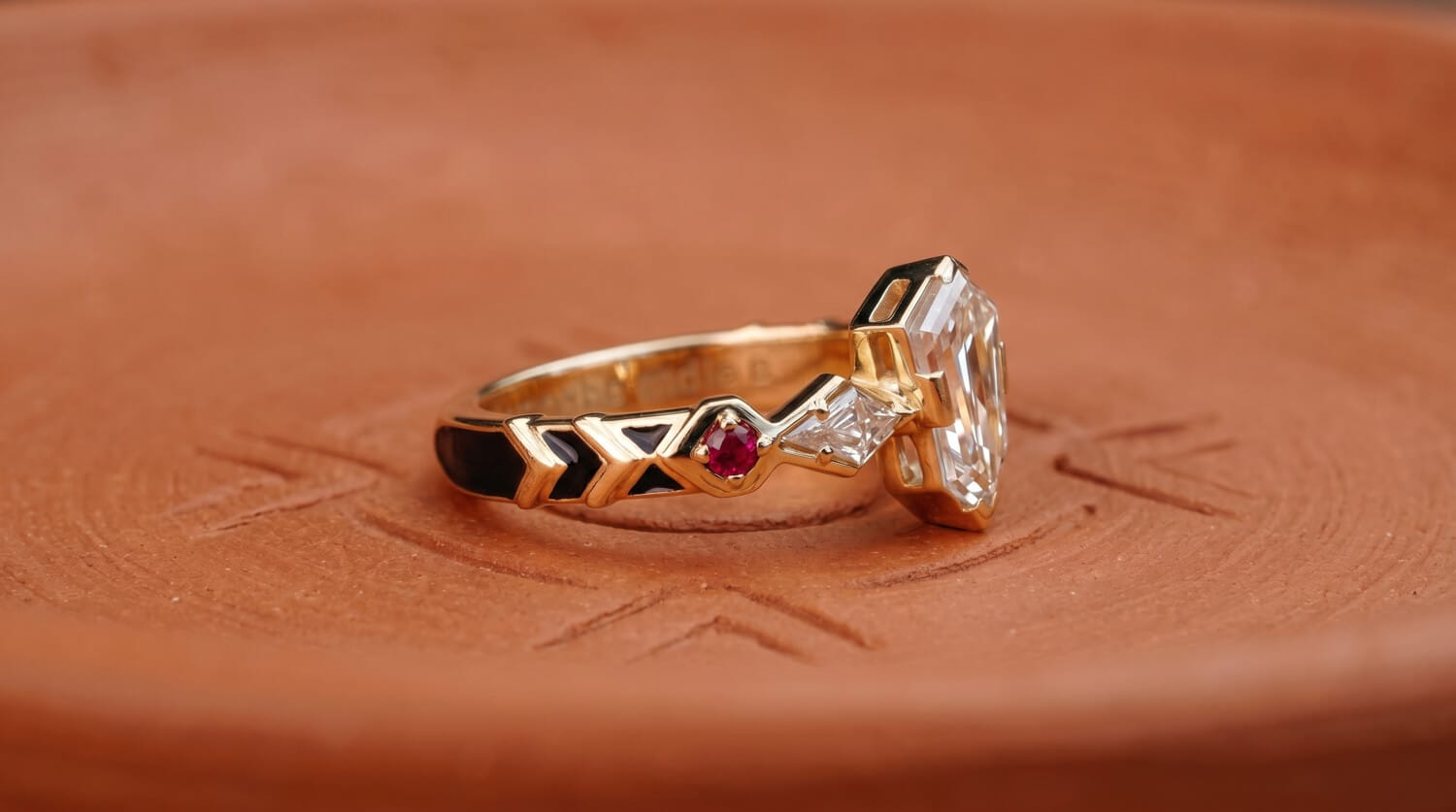 Three-stone diamond engagement ring with small ruby accents