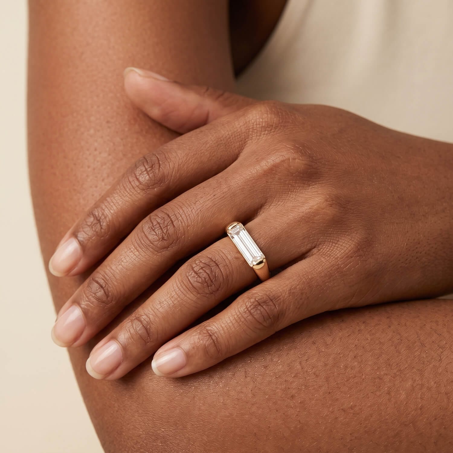 Minimalist baguette diamond solitaire worn on the hand
