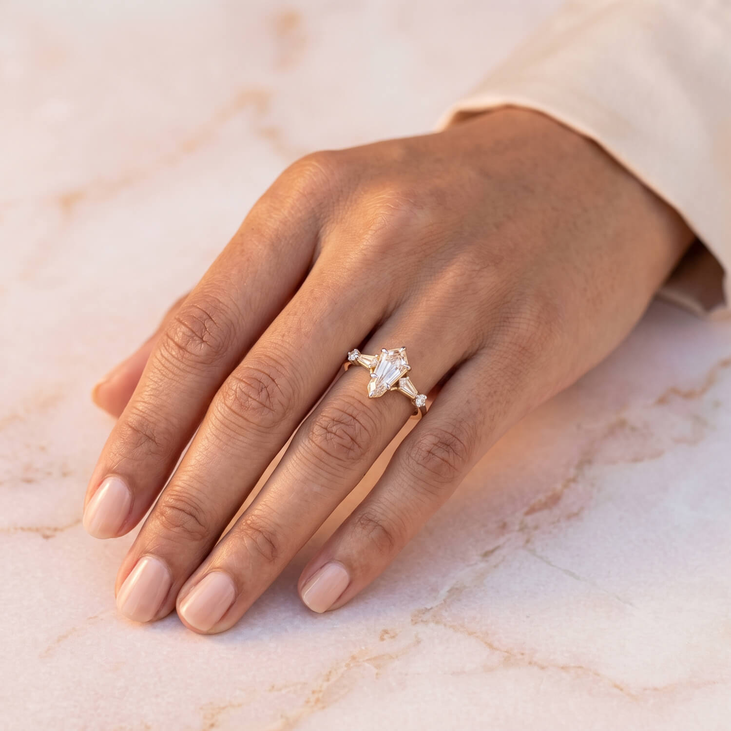 Bohemian kite-shaped diamond engagement ring on hand